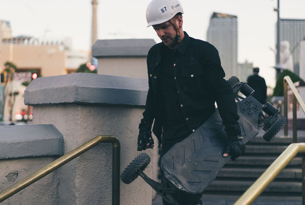 ONSRA rider commuting on an electric skateboard in a typical American city