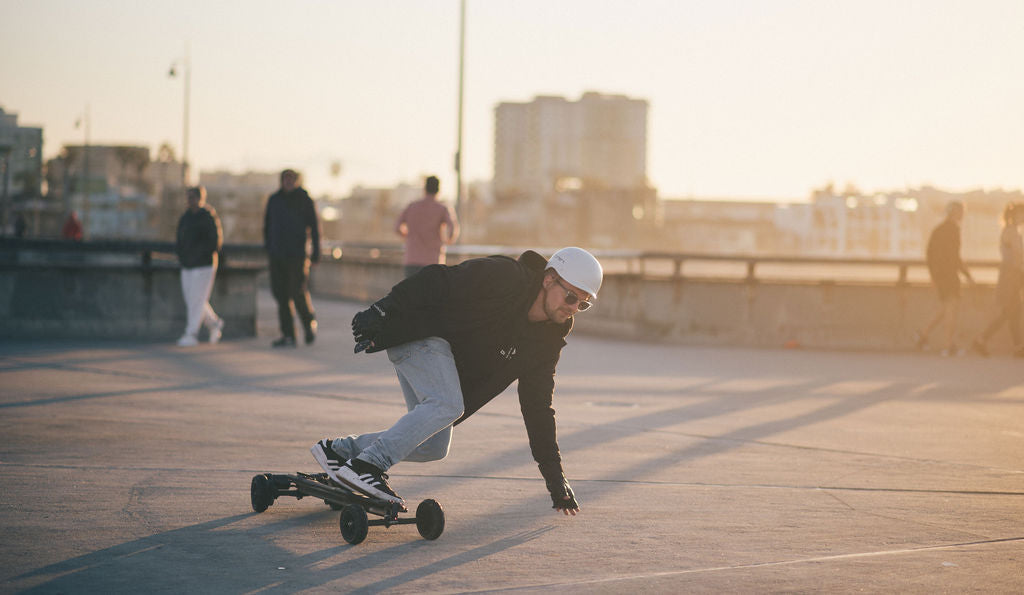 ONSRA electric skateboard riding at high speed on an American road