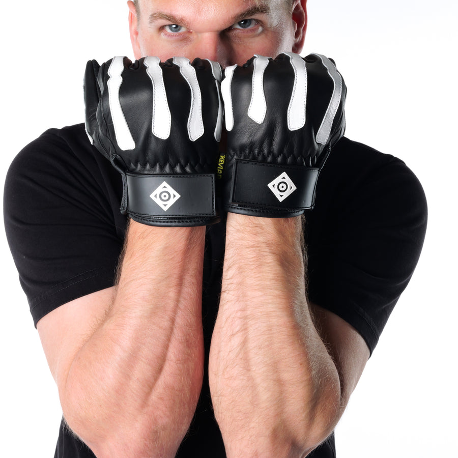 ONSRA BONES KEVLAR motorcycle gloves with white skeleton design and Kevlar reinforcement worn by a rider in a black shirt.